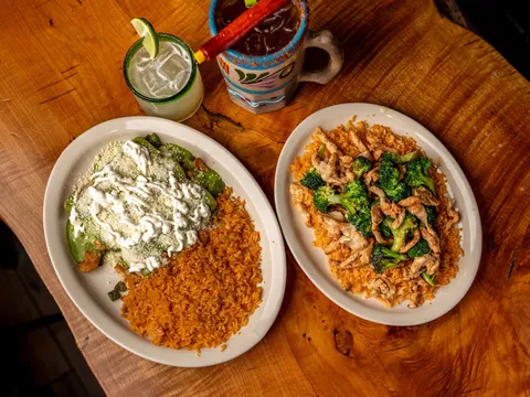 Two entree plates with rice and a drink at Cilantro Mexican Grill